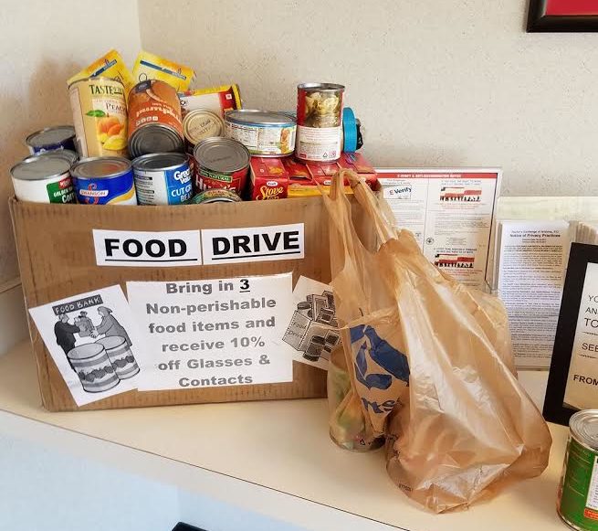 Associates donating food to food drive