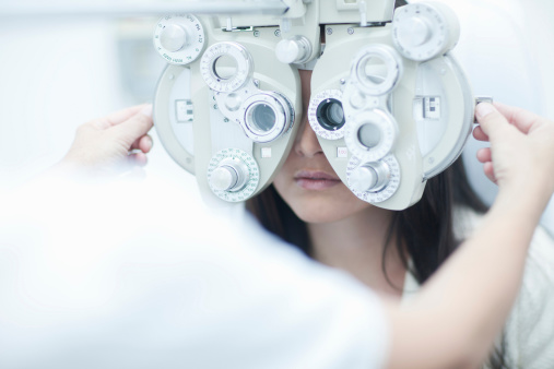 Optometrist checking patient's vision