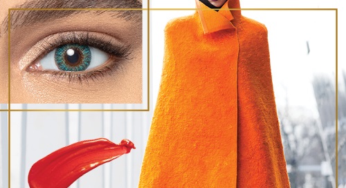 Woman wearing orange cape and Green Air Optix contact lenses